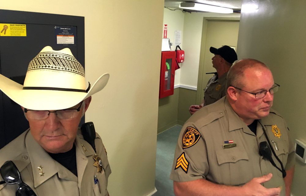 Crook County Sheriff John Gautney, left, and Sgt. Jeremy Bottoms prepare to pass through a secure door to the prisoner area of the Crook County Jail in Prineville, Ore., on July 1, 2016. "I personally think this is an embarrassment to our community," Gautney says of the 16-bunk jail in central Oregon. (AP Photo/Andrew Selsky)